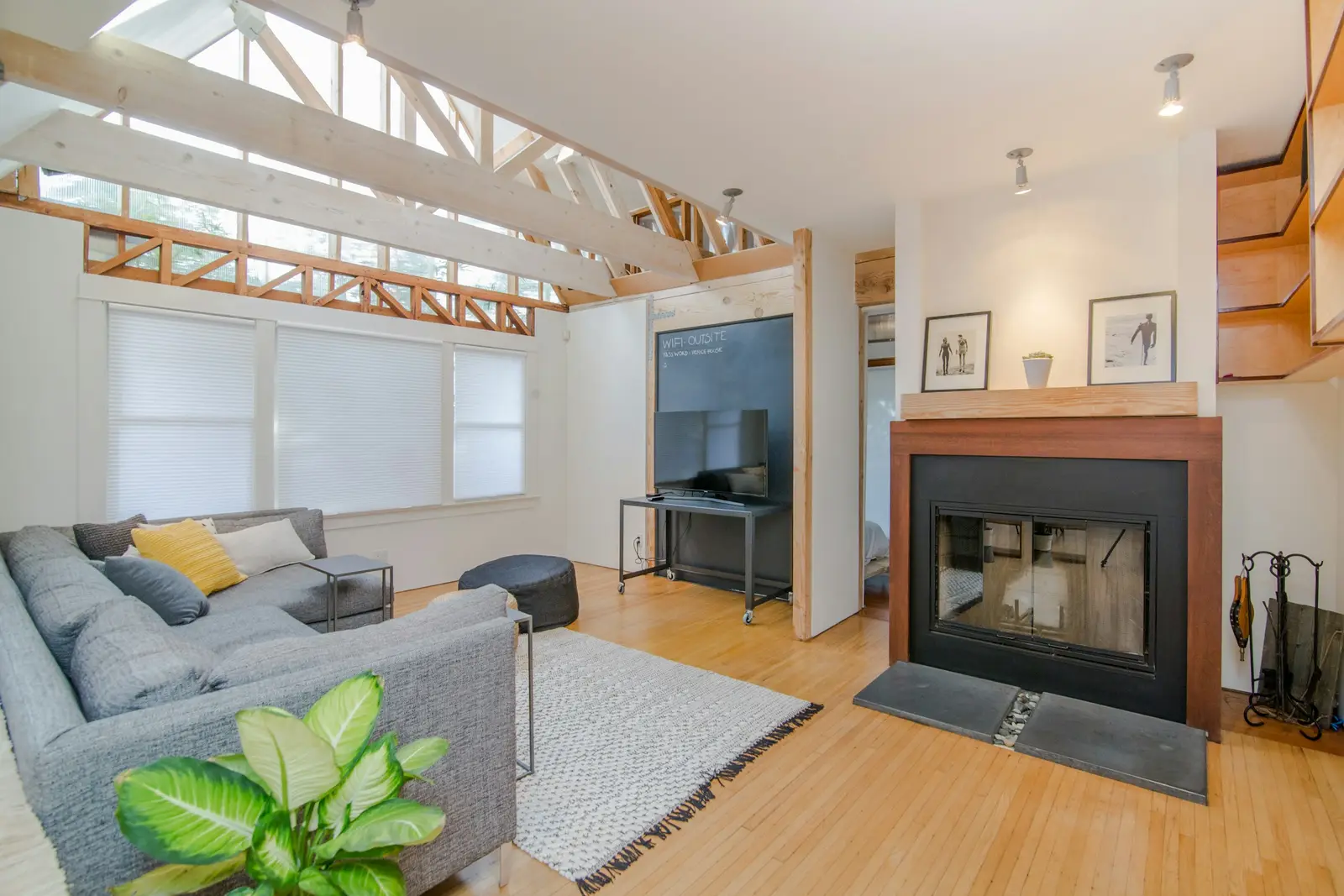 A comfortable family room with a sectional sofa, a fireplace, and natural light